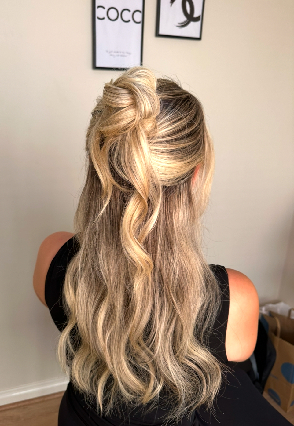 Back view of a blonde half-up, half-down bridal style with soft waves