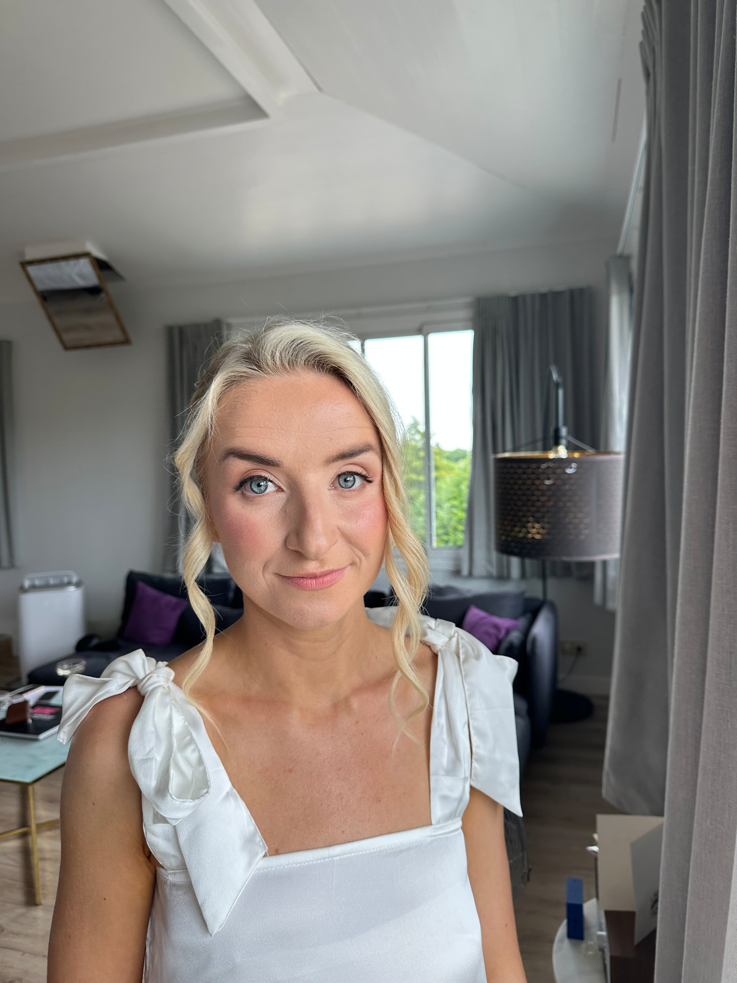 Real bride with blonde face-framing waves, fresh blush and a soft pink lip