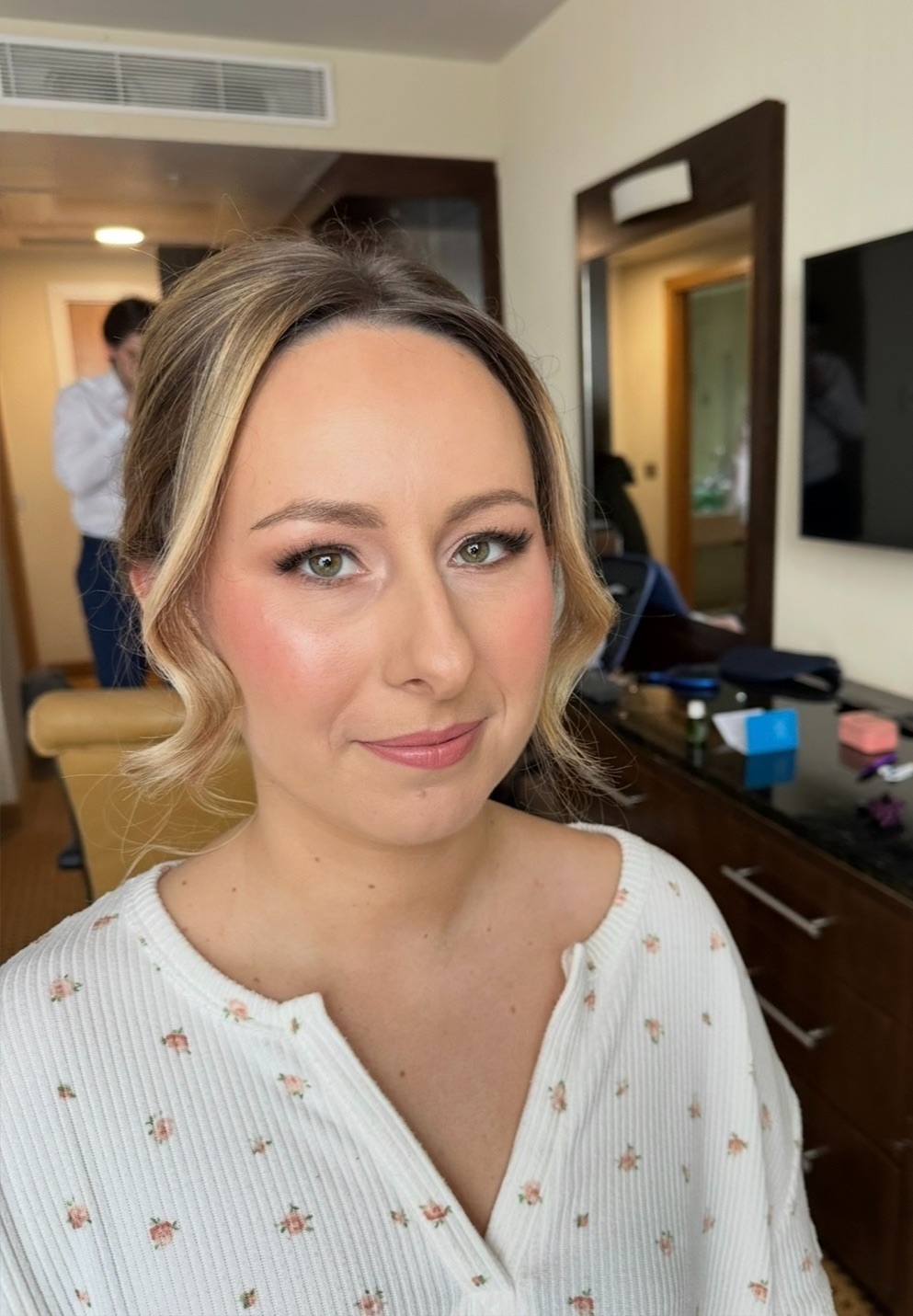 Real bride with soft blush, fluttery lashes and a glossy nude lip, blonde hair pinned into a soft updo