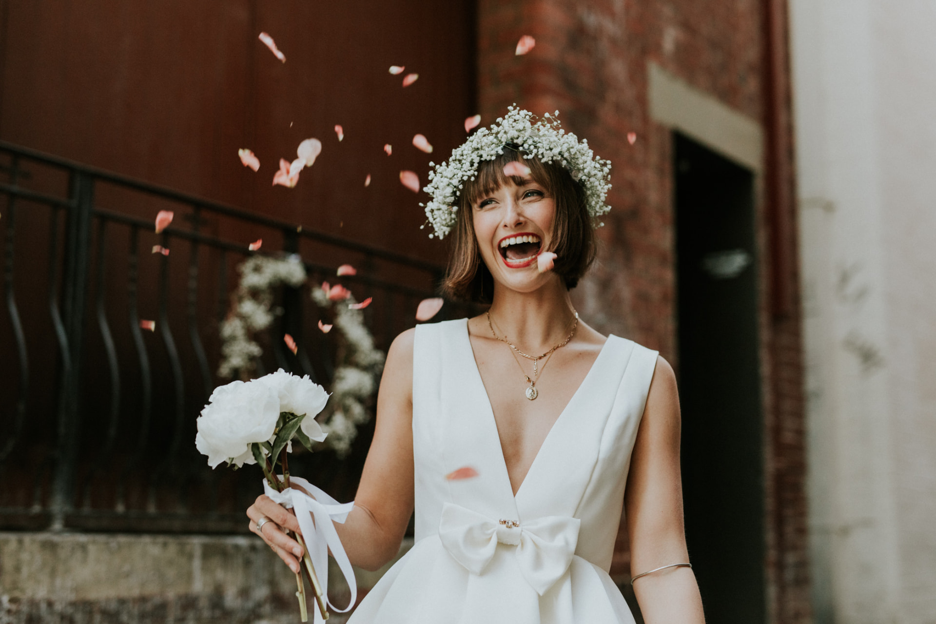 Real bride laughing in confetti on her wedding day