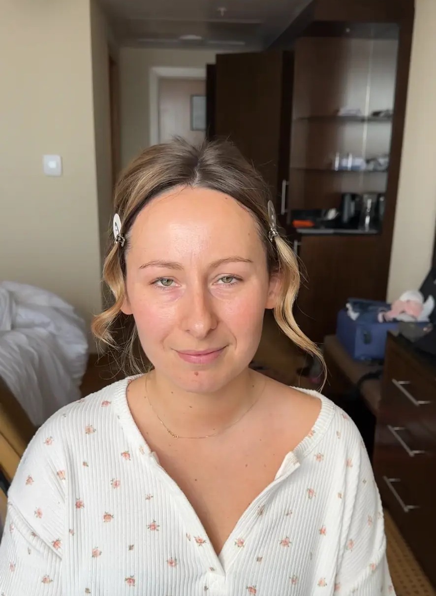 Jennifer before her bridal makeup, bare face with styling clips holding her hair back