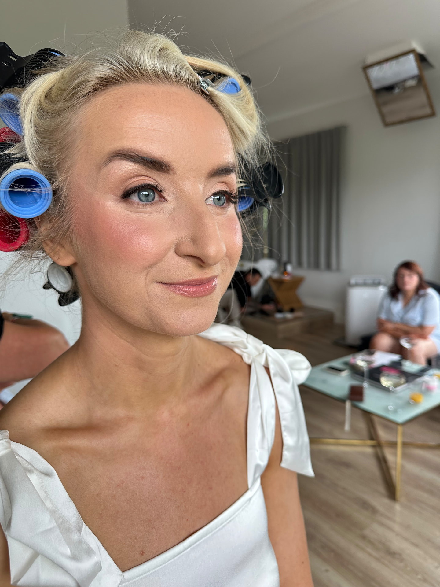 Abbi after her bridal soft glam makeup — even glowing base, warm blush, defined eyes and a soft pink lip