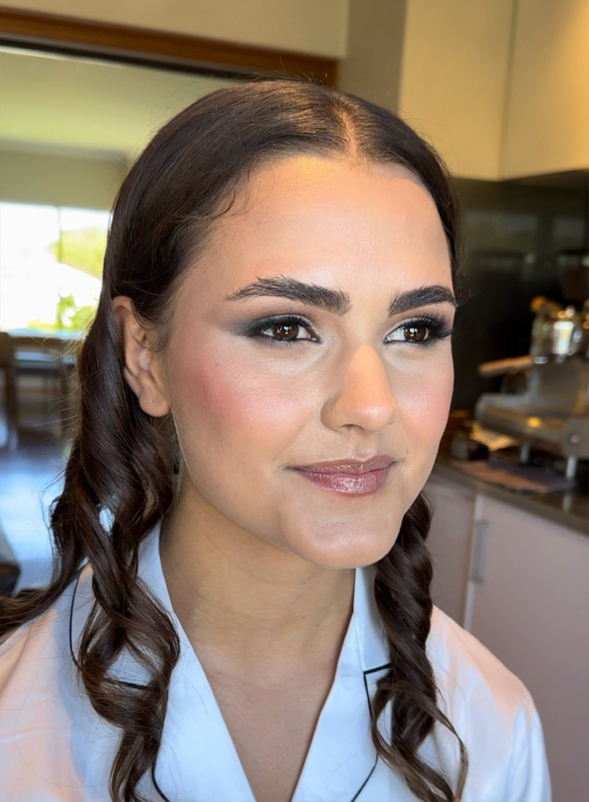 Real bride with smoky soft glam eyes, rosy blush and glossy lip, dark hair in soft curls