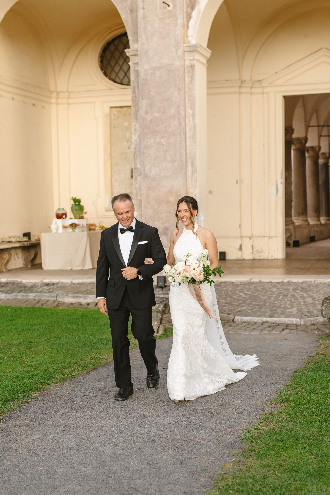 Bride walking to her ceremony at a beautiful wedding venue